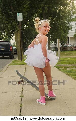 "Young girl wearing tutu and pink baseball boots, standing on skateboard" View Large Photo Image Stock Image - "Young girl wearing tutu and pink baseball boots, standing on skateboard". Fotosearch