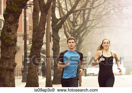 "Young man and woman running along misty tree lined street, Pioneer Square, Seattle, USA" View Large Photo Image Stock Photo - "Young man and woman running along misty tree lined street, Pioneer Square, Seattle, USA". Fotosearch