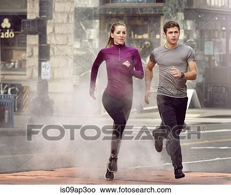 Picture - "Young man and woman running through steam, Pioneer Square, Seattle, USA". Fotosearch