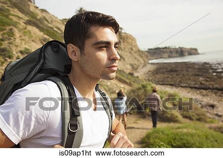 "Young man, at beach, looking at view" View Large Photo Image Stock Photograph - "Young man, at beach, looking at view". Fotosearch