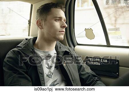 Young man gazing out from yellow cab window View Large Photo Image Stock Image - Young man gazing out from yellow cab window. Fotosearch