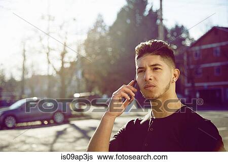 Young man on cell phone View Large Photo Image Stock Photograph - Young man on cell phone. Fotosearch