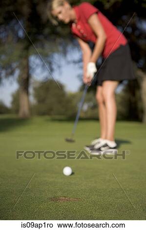 "Young woman playing golf, defocussed" View Large Photo Image Picture - "Young woman playing golf, defocussed". Fotosearch