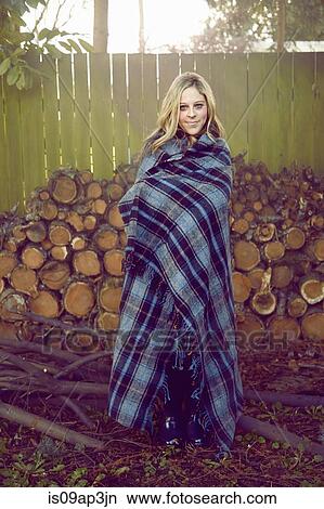Young woman wrapped in blanket View Large Photo Image Picture - Young woman wrapped in blanket. Fotosearch