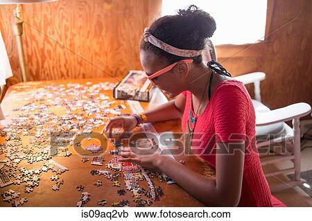 A young teenage girl doing a puzzle on summer vacation View Large Photo Image Stock Image - A young teenage girl doing a puzzle on summer vacation. Fotosearch