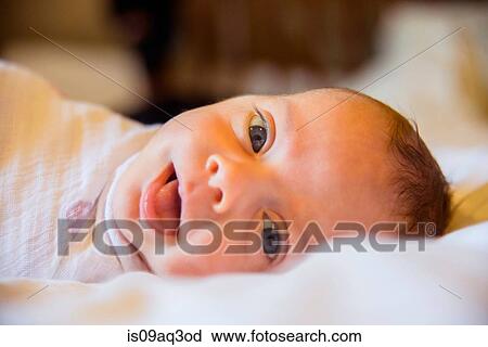Stock Image - Baby girl looking at camera. Fotosearch