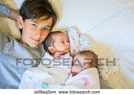 Big brother with twin baby sister and brother View Large Photo Image Picture - Big brother with twin baby sister and brother. Fotosearch