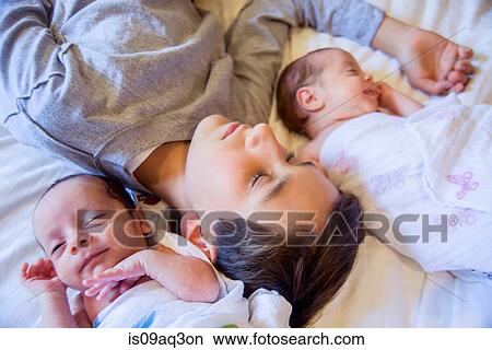 Picture - Big brother with twin baby sister and brother. Fotosearch