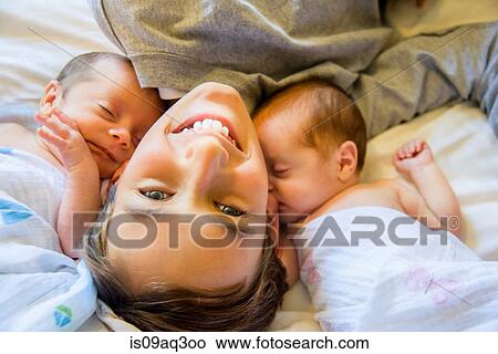 Picture - Big brother with twin baby sister and brother. Fotosearch