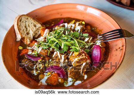 Bowl of stew with herb garnish on restaurant table View Large Photo Image Stock Image - Bowl of stew with herb garnish on restaurant table. Fotosearch