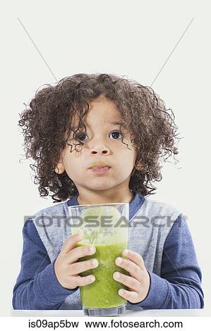 Boy drinking green smoothie View Large Photo Image Stock Photo - Boy drinking green smoothie. Fotosearch