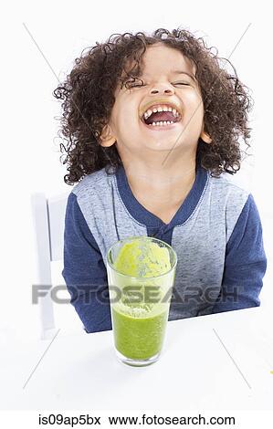Boy drinking green smoothie View Large Photo Image Stock Photo - Boy drinking green smoothie. Fotosearch