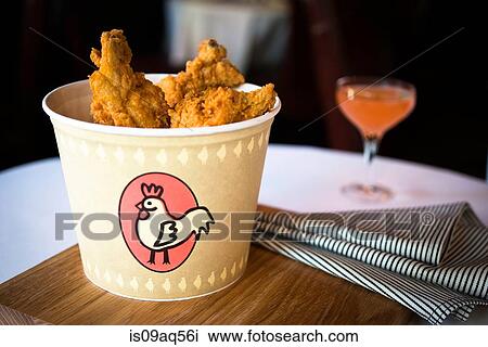 Bucket of fried chicken on restaurant table View Large Photo Image Stock Image - Bucket of fried chicken on restaurant table. Fotosearch