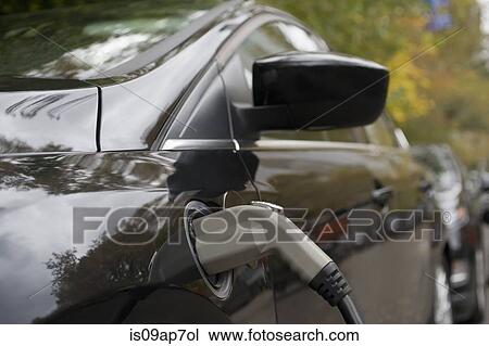 Stock Image - "Charging an electric car, close-up". Fotosearch