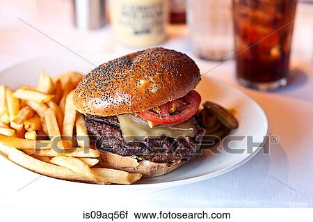 Cheese burger and french fries on restaurant table View Large Photo Image Stock Image - Cheese burger and french fries on restaurant table. Fotosearch