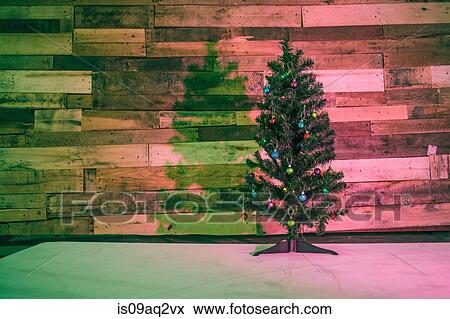 Stock Photo - Christmas tree in coloured light. Fotosearch