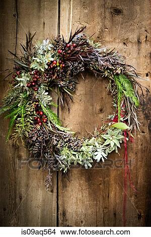Christmas wreath with foliage and berries on wooden door View Large Photo Image Picture - Christmas wreath with foliage and berries on wooden door. Fotosearch