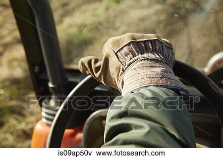 Close up of male hand driving tractor dairy farm field View Large Photo Image Stock Photo - Close up of male hand driving tractor dairy farm field. Fotosearch