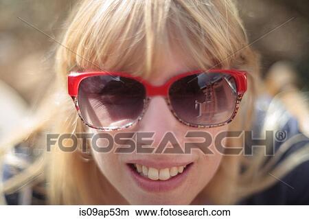 Close up portrait of woman with house exterior reflected in sunglasses View Large Photo Image Picture - Close up portrait of woman with house exterior reflected in sunglasses. Fotosearch