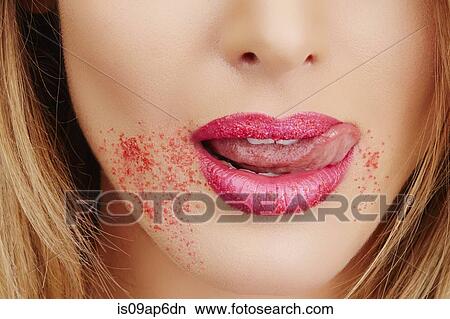 Picture - Close up woman with sugar around lips. Fotosearch
