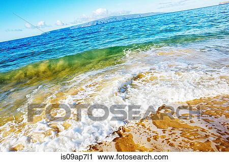Stock Image - Colourful backwash on sea shore. Fotosearch