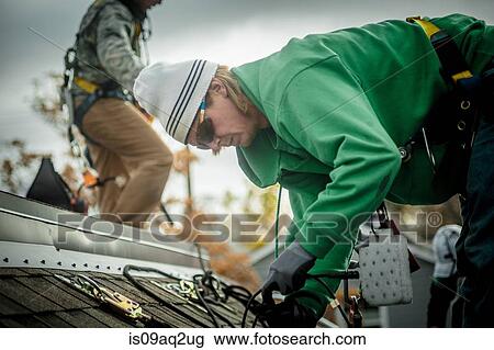 Construction crew installing solar panels on a house View Large Photo Image Stock Image - Construction crew installing solar panels on a house. Fotosearch