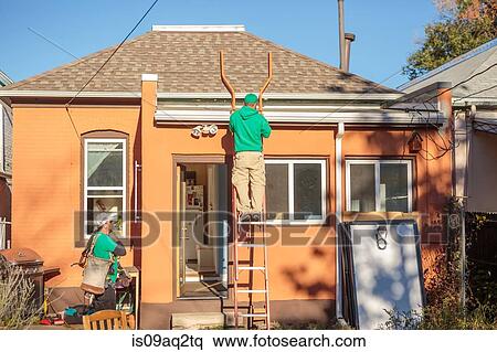 Construction crew installing solar panels on a house View Large Photo Image Stock Photography - Construction crew installing solar panels on a house. Fotosearch