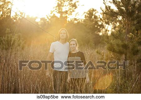 Couple in field in sunlight View Large Photo Image Stock Image - Couple in field in sunlight. Fotosearch