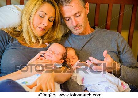 Stock Image - Couple with newborn twin girl and boy. Fotosearch