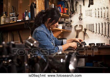 Stock Photograph - Female mechanic in workshop. Fotosearch