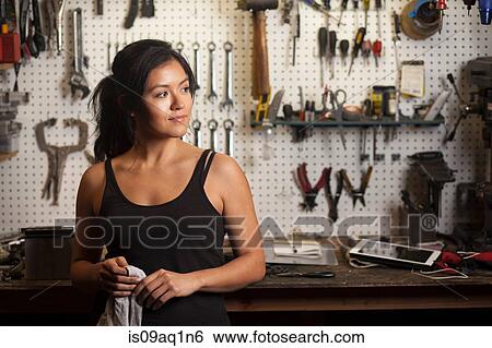 Stock Photograph - Female mechanic in workshop. Fotosearch
