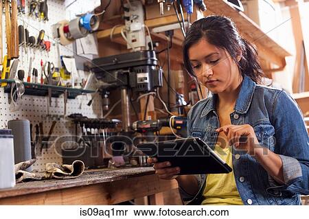Female mechanic using digital tablet in workshop View Large Photo Image Stock Photography - Female mechanic using digital tablet in workshop. Fotosearch