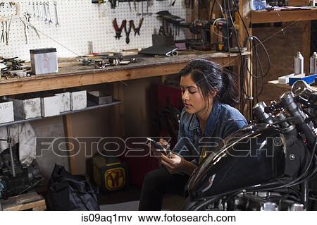 Female mechanic using mobile phone in workshop View Large Photo Image Stock Photo - Female mechanic using mobile phone in workshop. Fotosearch
