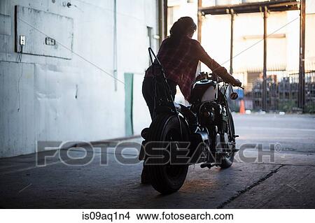 Female mechanic working on motorcycle in workshop View Large Photo Image Picture - Female mechanic working on motorcycle in workshop. Fotosearch