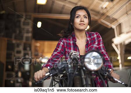 Female mechanic working on motorcycle in workshop View Large Photo Image Stock Photography - Female mechanic working on motorcycle in workshop. Fotosearch