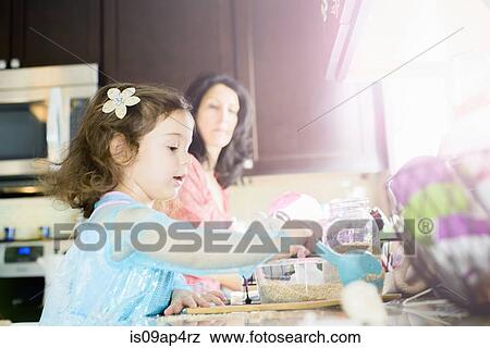 Female toddler and mother baking in kitchen View Large Photo Image Stock Photo - Female toddler and mother baking in kitchen. Fotosearch