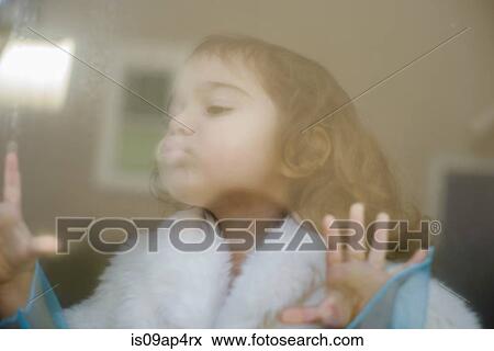 Stock Photo - Female toddler finger drawing on steamed up window. Fotosearch