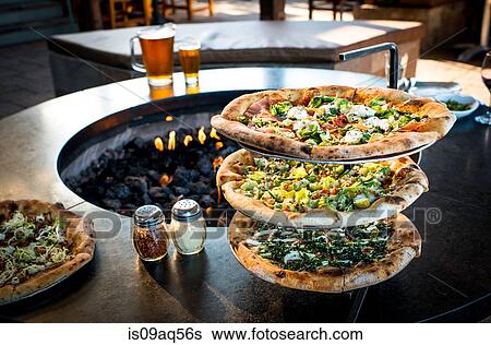 Fresh pizzas on stand by restaurant open fire View Large Photo Image Stock Photograph - Fresh pizzas on stand by restaurant open fire. Fotosearch
