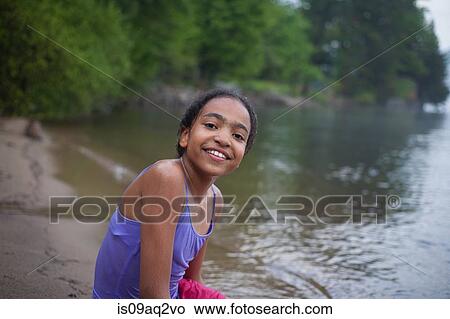 Picture - "Girl by water on summer vacation at Lake George, New York, USA". Fotosearch