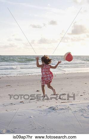 Girl exploring on the beach at sunset View Large Photo Image Stock Photography - Girl exploring on the beach at sunset. Fotosearch