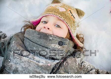 Girl lying on snow View Large Photo Image Stock Photograph - Girl lying on snow. Fotosearch
