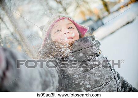 Stock Photograph - Girl playing with snow. Fotosearch