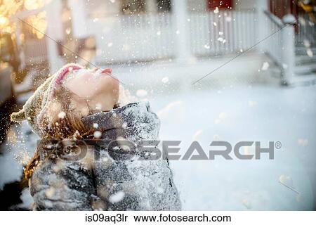 Stock Photography - Girl playing with snow. Fotosearch