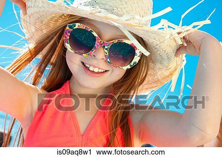 Girl wearing sunglasses and straw hat View Large Photo Image Stock Image - Girl wearing sunglasses and straw hat. Fotosearch