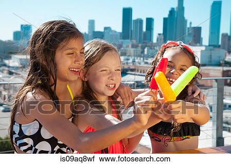 Girls eating ice lollies View Large Photo Image Stock Image - Girls eating ice lollies. Fotosearch