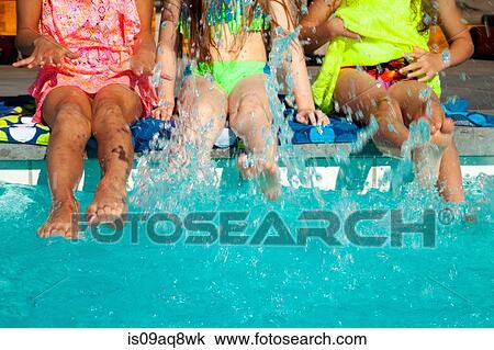 Girls paddling in swimming pool View Large Photo Image Stock Image - Girls paddling in swimming pool. Fotosearch