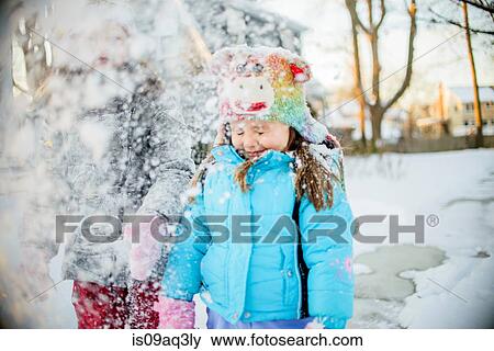 Stock Photo - Girls playing with snow. Fotosearch