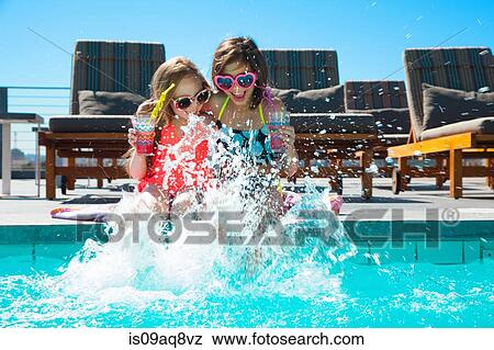 Girls sitting on poolside splashing water View Large Photo Image Stock Photo - Girls sitting on poolside splashing water. Fotosearch