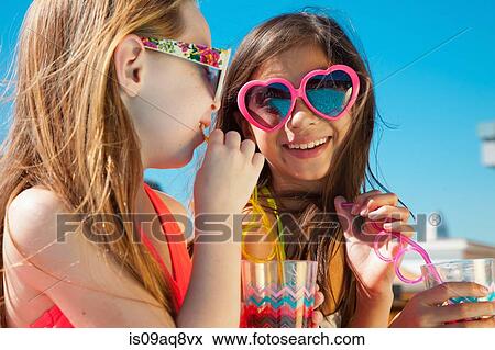 Stock Photo - Girls wearing sunglasses with drinks. Fotosearch