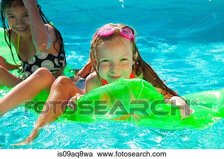 Girls with inflatable toy in swimming pool View Large Photo Image Stock Image - Girls with inflatable toy in swimming pool. Fotosearch